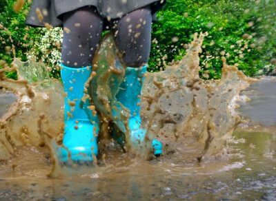 child stomping in the mud