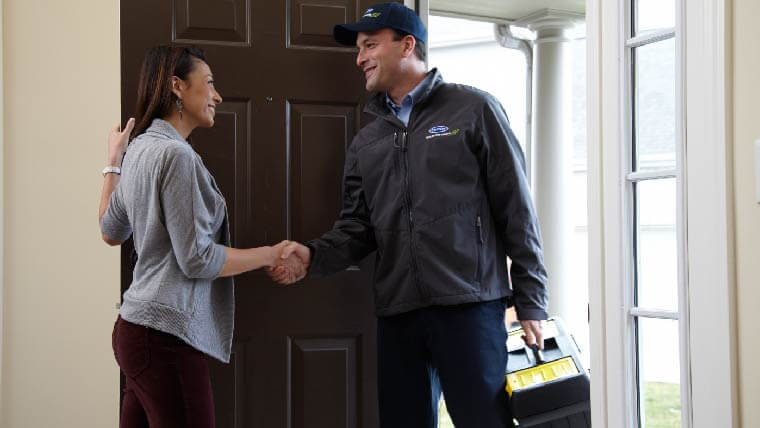 Greeting a Barbosa plumber at the front door - Barbosa is the go-to plumber in Flower Mound, TX. Call us for help with your pipes, fixtures, or drains.