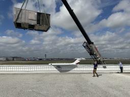 A crane lifting a new commercial rooftop system in Carrollton. For commercial AC installation, repair, replacement, and maintenance, trust Barbosa Plumbing & Air Conditioning.