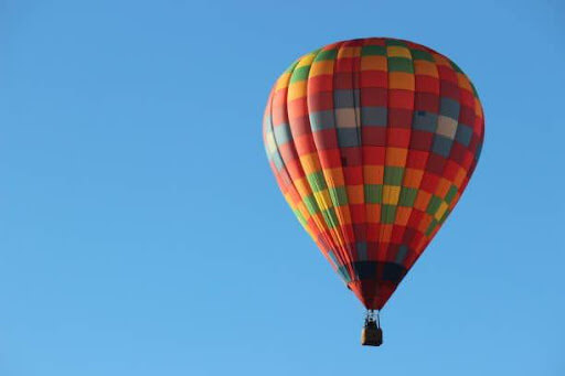 Hot air balloon in Texas sky - Lighten your load and let our technicians handle your AC system needs in Plano, TX—call (214) 351-7030 today.
