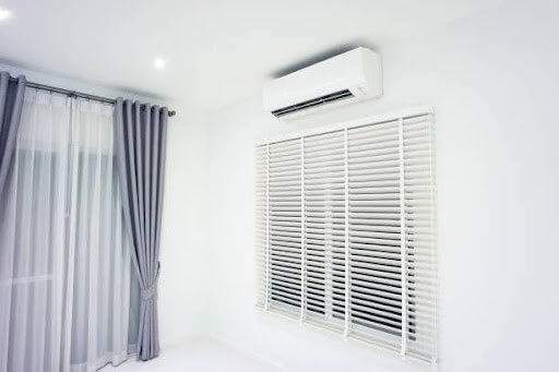 Ductless AC mounted over window - Barbosa Plumbing & Air Conditioning provides ductless mini split repairs, replacements, and maintenance in Plano, TX.